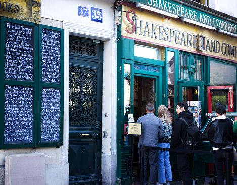 Paris, France: A line of tourists waiting outside Shakespeare and Company Bookstore, located on the Seine opposite Notre Dame Cathedral.
