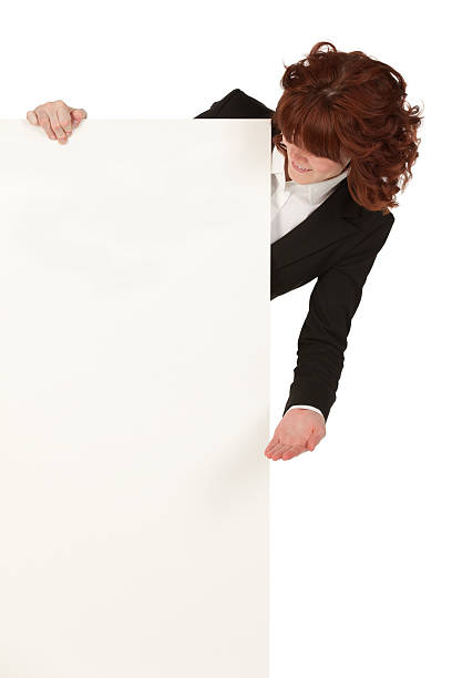 donna d'affari alla ricerca di un manifesto - advertisement advertise businesswoman peeking foto e immagini stock