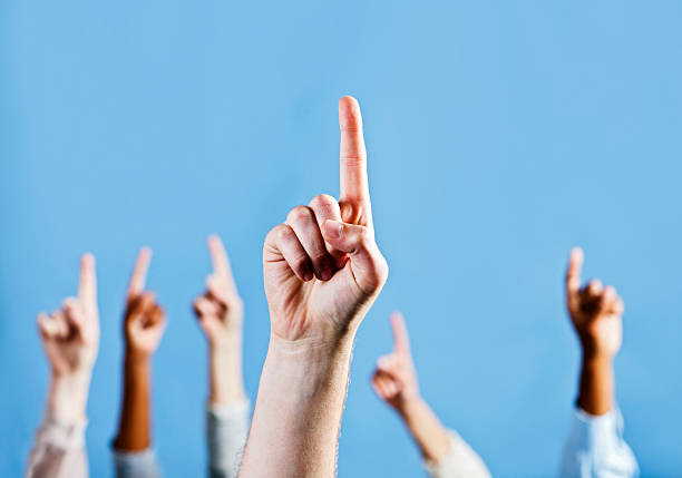 istock Many hands point up at something in the blue above 184838845