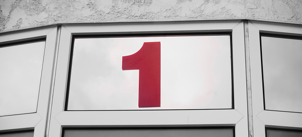 number one in red on building facade