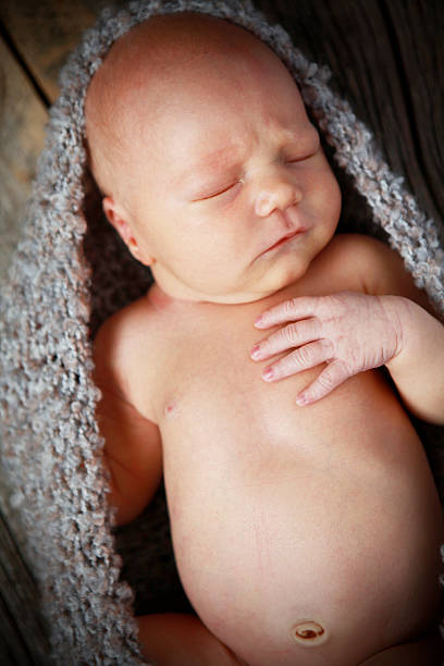 istock Newborn Baby Sleeping in Knit Cocoon 184839641