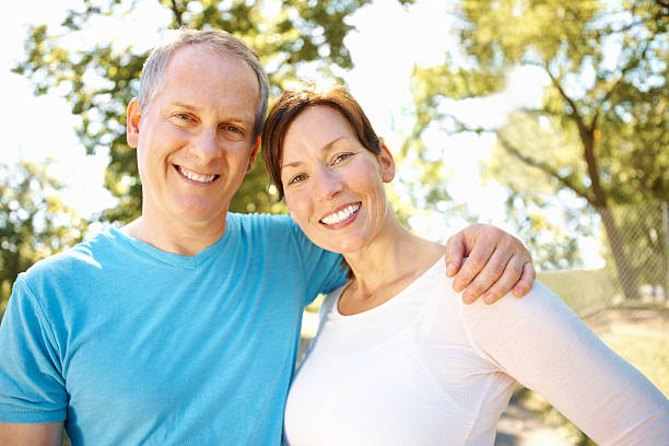 istock Middle aged couple smiling outdoors 184839751