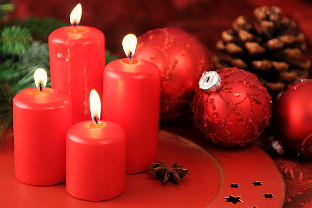 istock four burning Advent candles with pine twig and cone 184839890