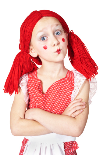 Little girl dressed as a rag doll.
