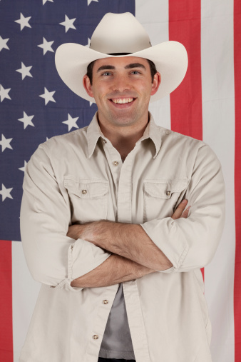 Cowboy standing in front of American flaghttp://www.twodozendesign.info/i/1.png