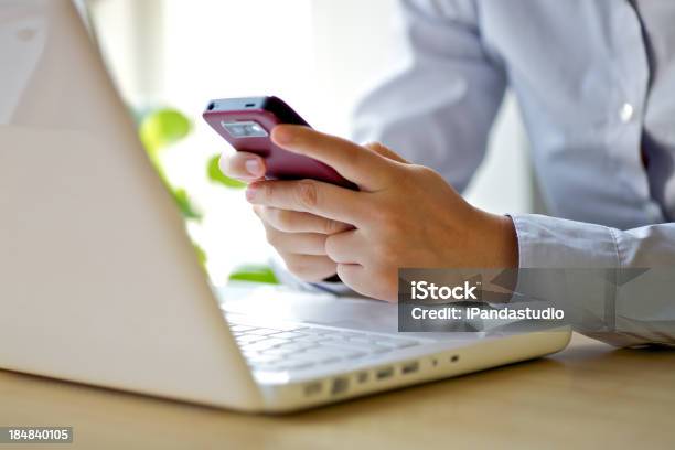 A Businesswoman Using Her Smartphone And Laptop Stock Photo - Download Image Now - Adult, Adults Only, Business