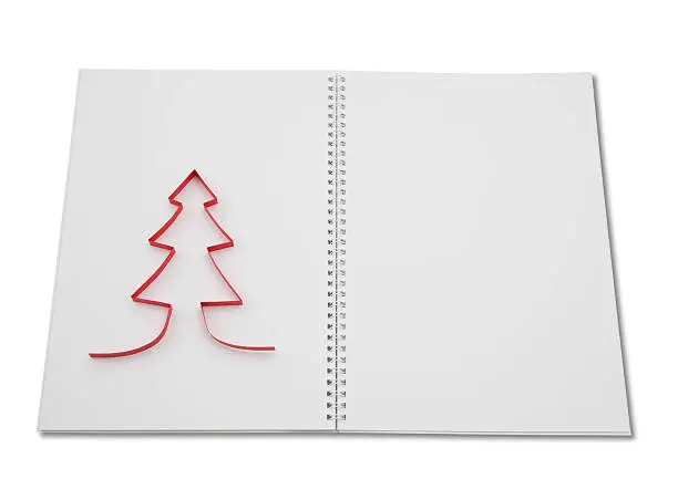 open blank notepad with red paper xmas-tree on the left side, right side is empty. Wire-O binding, drop shadow, clipping path included