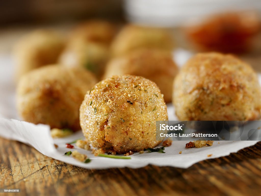 Arancini - Wikipedia Deep Fried Mushroom Risotto Balls with Fresh Italian Parsley and Parmesan Cheese with a Tomato Pesto Dipping Sauce-Photographed on Hasselblad H1-22mb Camera Croquette Stock Photo
