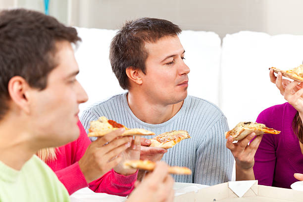 istock Friends eating pizza 184841627