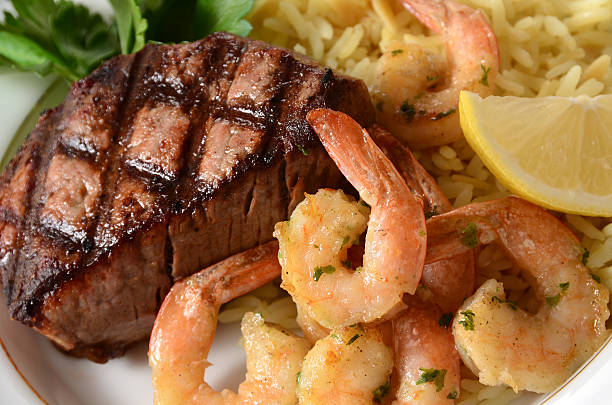 surf and turf - surf and turf prepared shrimp steak grilled fotografías e imágenes de stock