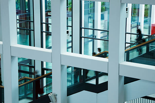 istock People on Escalators, Lobby of a Modern Office Building 184843285