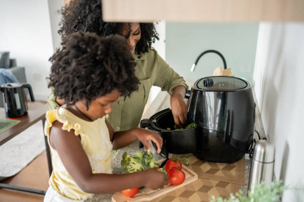 istock Mother teaching daughter how to prepare vegetables 1848437234