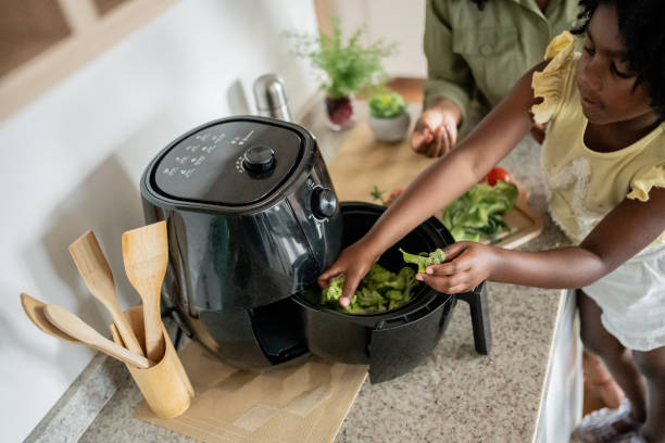 istock Mother teaching daughter how to prepare vegetables 1848438794