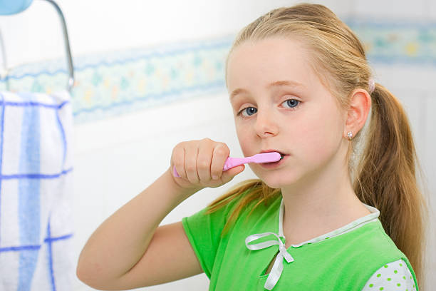 istock Little girl brushing teeth 184843999
