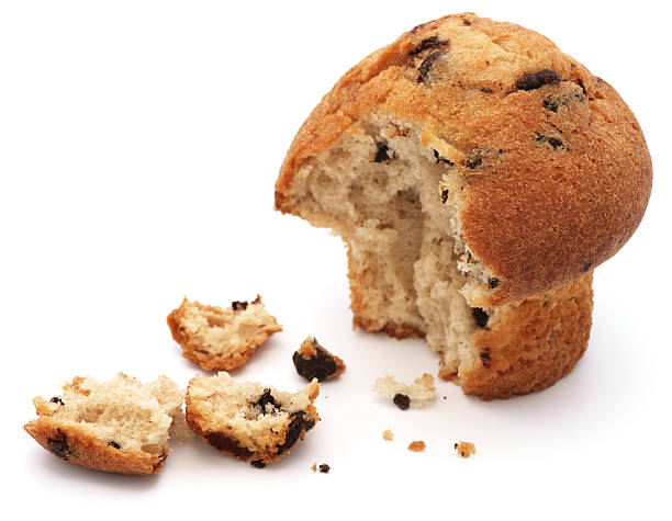 Half eaten chocolate chip muffin isolated on white