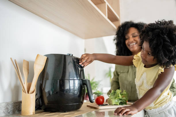 istock Mother teaching daughter how to prepare vegetables 1848444354