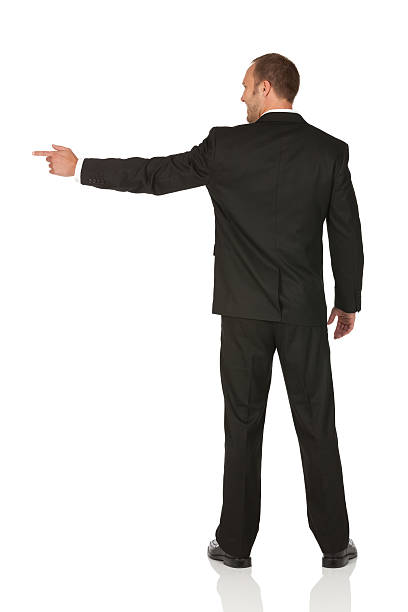 istock Rear view of a businessman pointing sideways 184844571