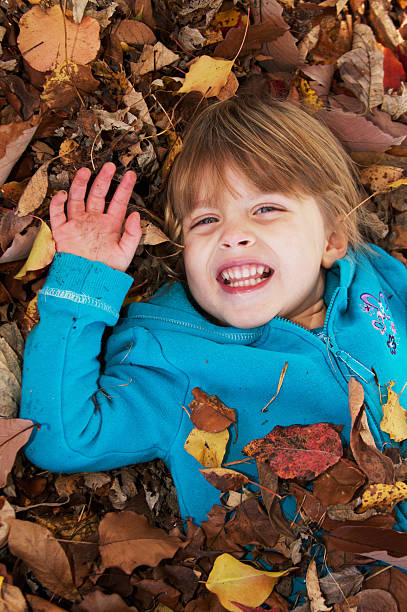 istock Little Girl Playing Leaves 184844601