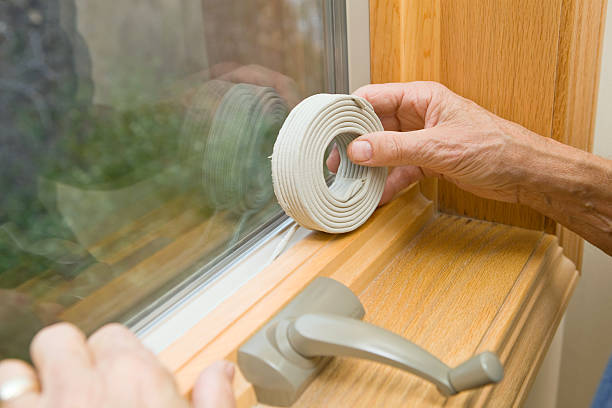 Hands Applying Weather Seal Caulk to Window Frame  crank mechanism photos stock pictures, royalty-free photos & images