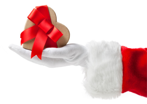 Hand of Santa Claus with heart-shaped gift.Similar photographs from my portfolio: