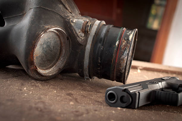 istock Gas Mask and Hand Gun Resting on Old Table 184845635