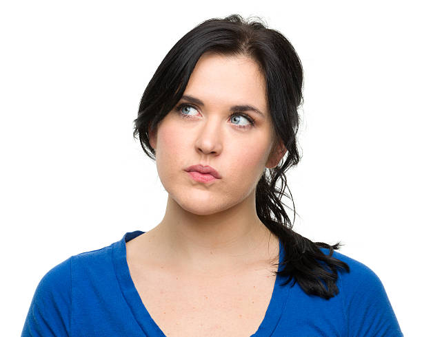 istock Young woman caught in thoughts over a white background 184845885