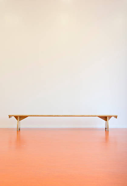 istock Wooden bench in front of a wall 184846022