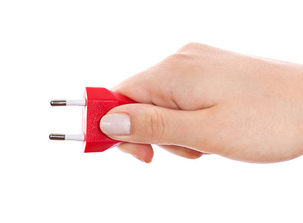 red european plug in woman hand on white