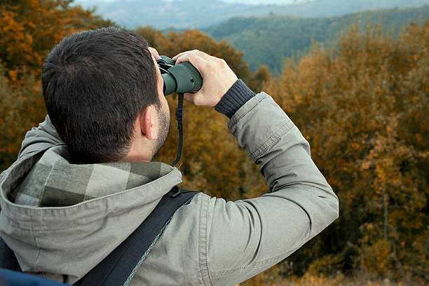 istock Tourist with binoculars in the mountains 184846294