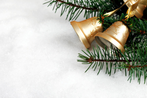 Close-up Christmas bells hanging on christmas tree and light