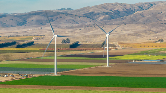 Aerial view of agriculture farming with wind turbines at Camphora, an unincorporated community in Monterey County, California.