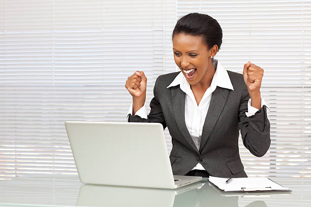 istock Businesswoman cheering while looking at laptop screen 184846451