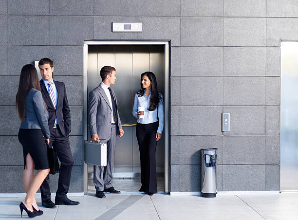 Business people outside the elevator Business people outside the elevator outdoor elevator stock pictures, royalty-free photos & images