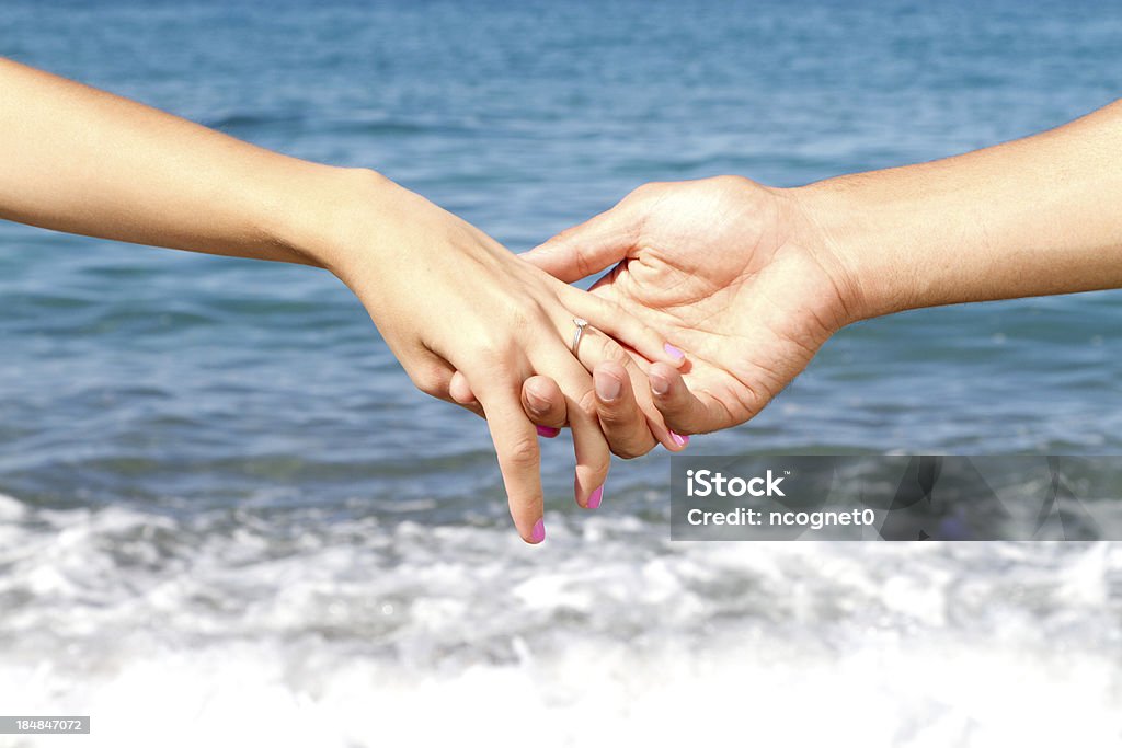 Holding hands mans hand holding a woman's hand Adult Stock Photo