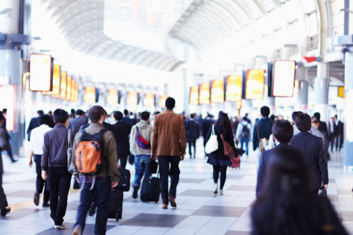 People walking toward the station