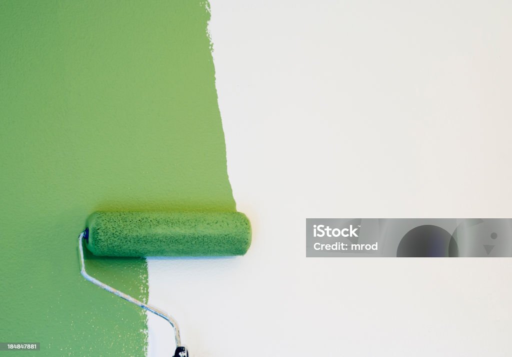 Paint Roller Painting a Wall Green paint being applied to an off-white wall with a roller. Adobe RGB color space. Painting - Activity Stock Photo