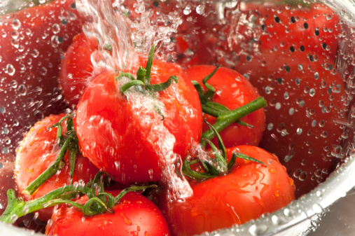 Close up of tomatoes being washed