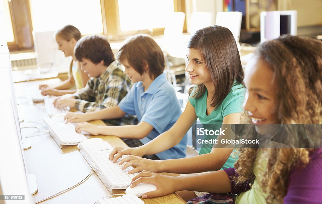 Group of school students Group of children at computer terminals Beautiful People Stock Photo