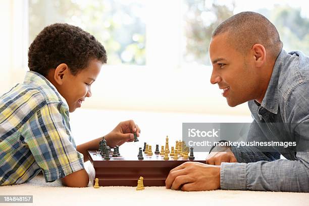 Father Playing Chess With Son Stock Photo - Download Image Now - Chess, Playful, Playing