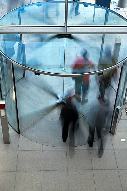 istock People Exiting Building Through Revolving Door 184848275