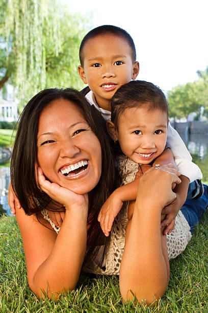 Happy mother with her son in arms look at each other - Mother and child love