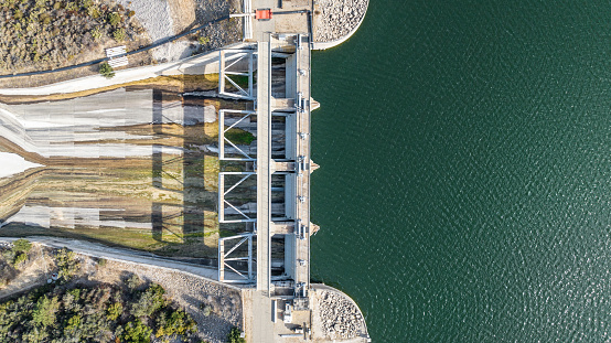 Water flowing from dam aerial landscape view