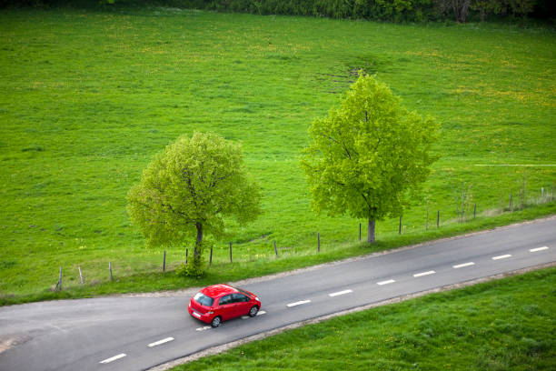 istock Small Red Car Driving Fast on Country Road 184848536