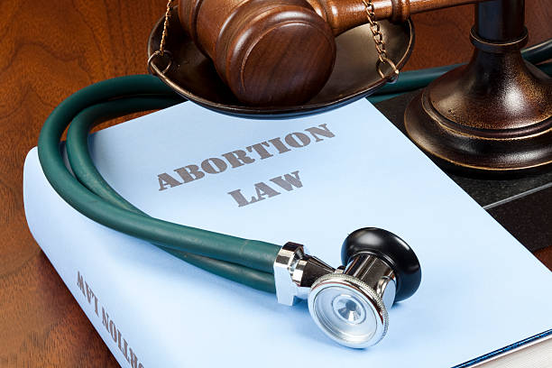 Abortion law "Concept shot. Gavel, stethoscope and scale of justice next to Abortion Law book." abortion photos stock pictures, royalty-free photos & images