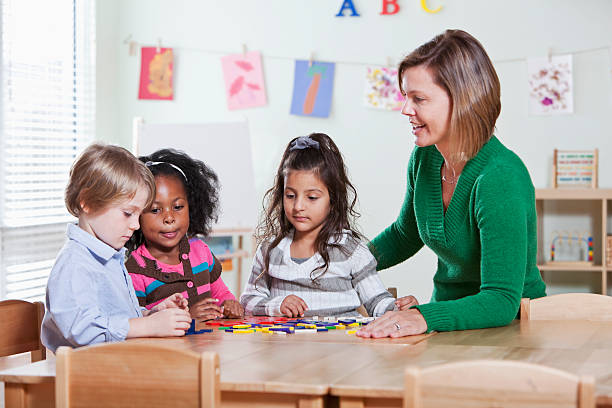 istock Preschool students with teacher in classroom 184849782