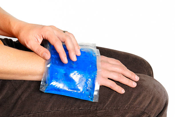 gel pack on wrist Cool gel pack on a swollen hurting wrist. physical injury sport ice pain stock pictures, royalty-free photos & images