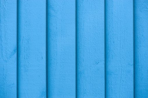Full frame view of blue paint on the wooden wall
