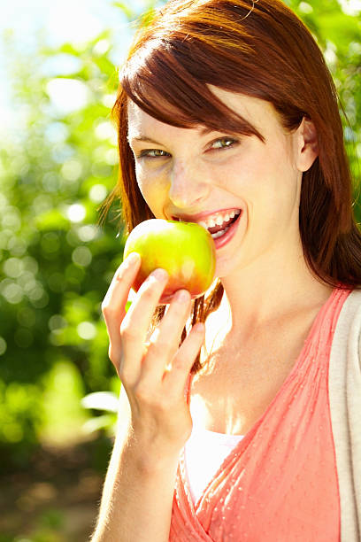 istock Woman eating apple 184851260