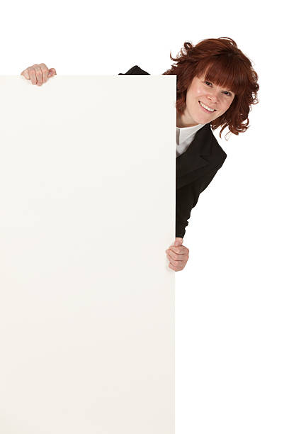 donna in carriera sbirciare dietro un manifesto - advertisement advertise businesswoman peeking foto e immagini stock