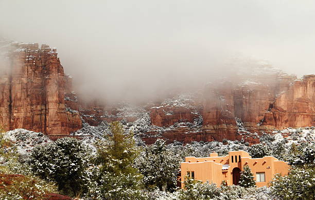 Southwest House Winter Snow Red Rock A winter scene of a southwestern house with a red rock backdrop. santa fe new mexico mountains stock pictures, royalty-free photos & images